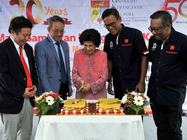 Tun Dr Siti Hasmah (tengah) memotong pulut kuning sebagai simbolik Sambutan Ulang Tahun Ke-20 Rumah Ronald McDonald (RRM) di Hospital Canselor Tuanku Muhriz Universiti Kebangsaan Malaysia (HCTM-UKM) pada majlis sambutan yang diadakan hari ini. - Foto: BERNAMA