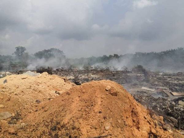 Kawasan tapak sampah haram yang masih berasap. - Foto JBPM Johor