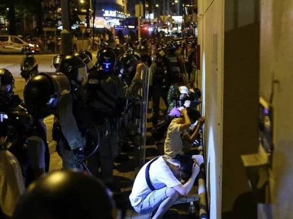 Polis Hong Kong menahan penunjuk perasaan pro-demokrasi ketika protes di daerah Mong Kok, semalam.- Foto AFP 