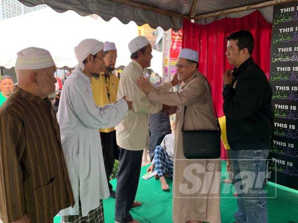 Mohd Amar (dua dari kanan) bersalaman bersama orang ramai yang mengikuti kuliah mingguan di Medan Ilmu hari ini. - Foto Sinar Harian