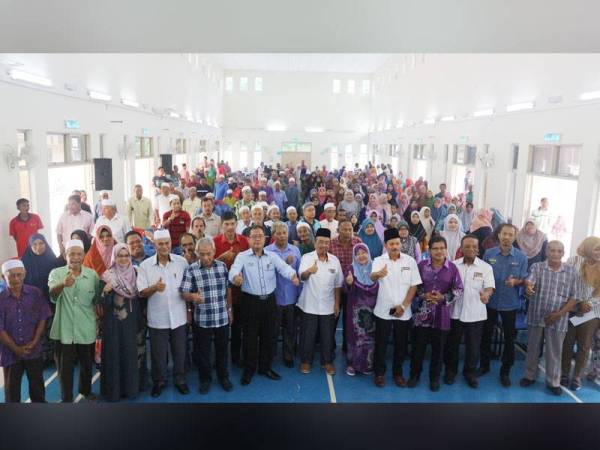 Phahrolrazi bergambar bersama penerima zakat yang hadir pada Program Kasih Peladang Kedah PPK Lubuk Batu di sini semalam. 