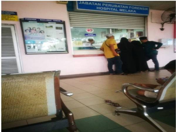 Waris keluarga mangsa dilihat sedang berurusan dikaunter Jabatan Forensik di Hospital Melaka di sini hari ini.