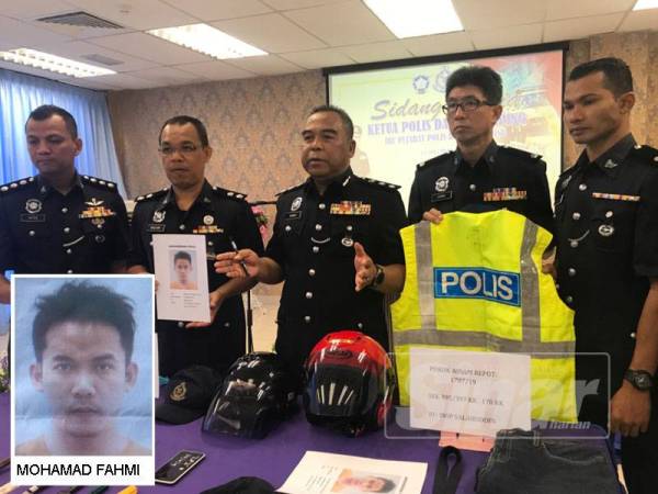 Osman (tengah) menunjukkan barang-barang yang dirampas daripada dua suspek yang menyamar sebagai anggota polis sebelum melakukan jenayah samun.