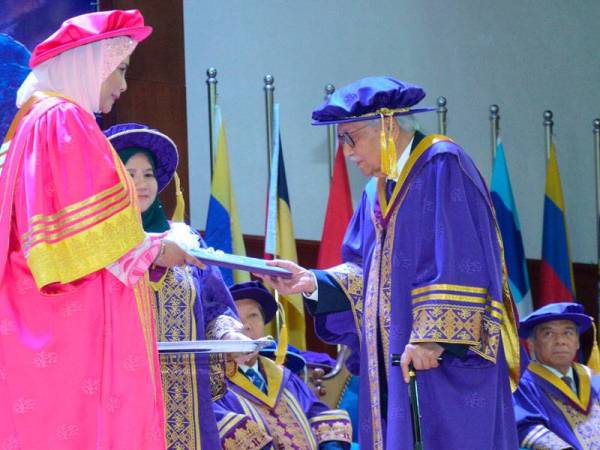 Daim (kanan) menerima Anugerah Ijazah Kehormat Doktor Ekonomi daripada Canselor Universiti Malaysia Terengganu (UMT), Sultanah Terengganu Sultanah Nur Zahirah (kiri) pada Majlis Konvokesyen UMT ke-17 hari ini. -FOTO: BERNAMA