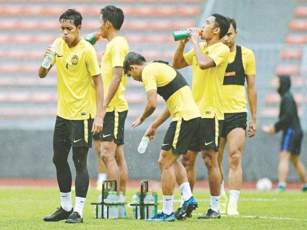 Syahmi (kiri) bersama pemain Harimau Malaya lain berehat seketika semasa sesi latihan skuad tersebut sebagai persediaan menjelang perlawanan menentang Indonesia malam esok. - Foto Bernama