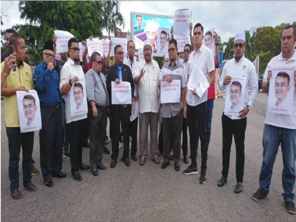 Akmal (tiga dari kanan) dan Hishamuddin (empat dari kanan) sebelum penyerahan memorandum bantahan di luar pekarangan bangunan Seri Negeri, Ayer Keroh di sini hari ini.