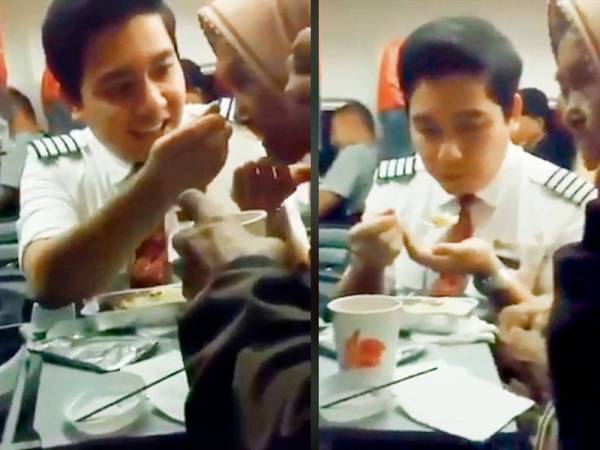 Tangkapan layar video yang menunjukkan seorang pramugara Lion Air sedang menyuap makanan kepada seorang warga emas.