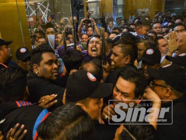 Kekecohan berlaku selepas perwakilan cuba merempuh pintu masuk selepas dihalang memasuki dewan sempena Kongres AMK di MITC hari ini. - FOTO SHARIFUDIN ABDUL RAHIM