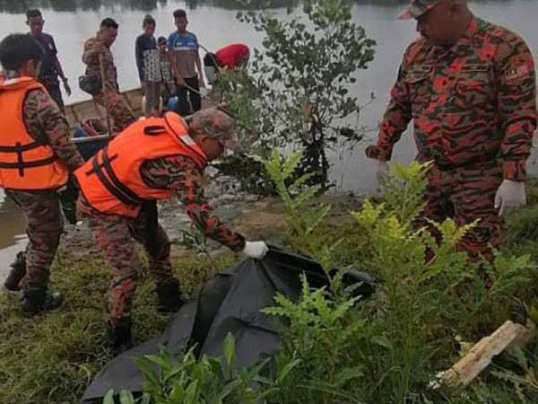 Anggota bomba membawa mayat lelaki yang sudah kembung ke tebing Sungai Permas semalam.