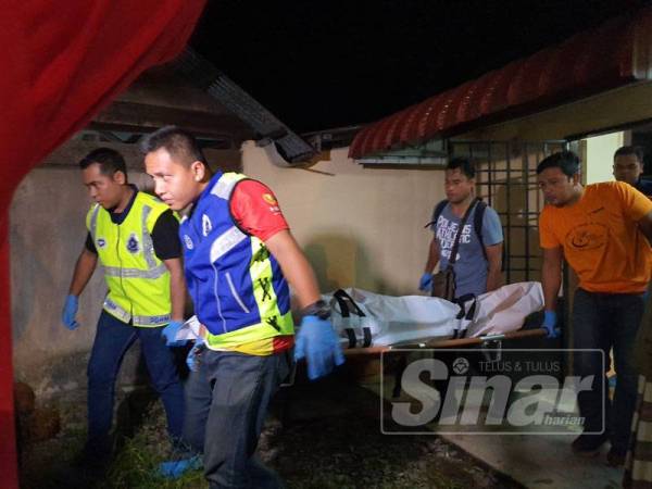 Anggota polis mengangkat mayat mangsa untuk dibawa ke Unit Forensik Hospital Seberang Jaya.