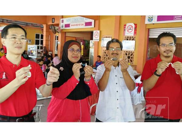 Dari kiri: Dr Tan, Dr Nor Azimi, Tun Ahmad Faisal dan Mohd Huzairil mematahkan rokok sebagai gimik larangan merokok di tempat makan di sini hari ini.