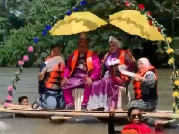 Tular video pasangan pengantin bersanding menaiki rakit di Sungai Perak, Kampung Jawang, Kuala Kangsar, Perak.