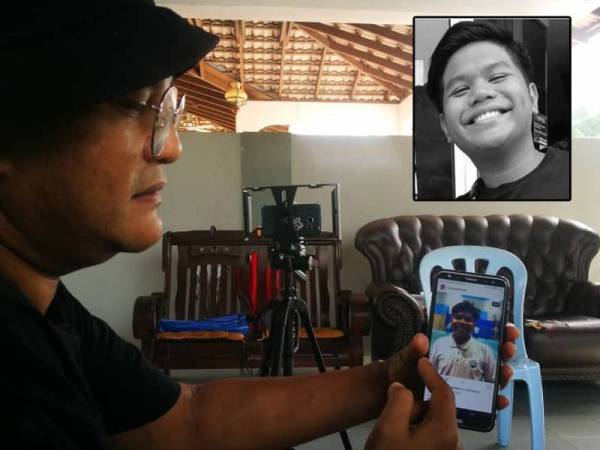 Azahari menunjukkan gambar Muhammad Farhan Fudhail di telefon bimbitnya. 