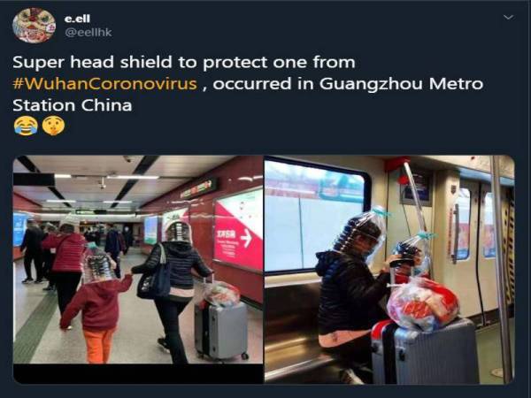 Dua beranak melindungi bahagian muka diperbuat dari botol air mineral untuk dijadikan 'face shield' di lokasi stesen kereta api di Guangzhou.