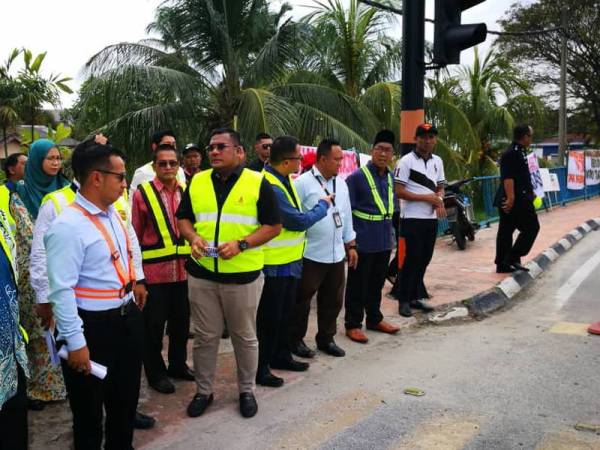 Jusni (dua dari kiri) dan Adhif Syan ketika melawat lokasi kemalangan maut di Jalan Banting-Dengkil, Olak Lempit Banting di sini petang tadi.