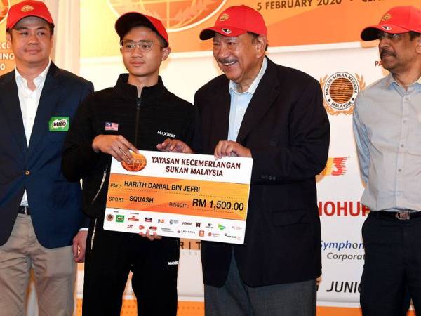 Tunku Imran (dua dari kanan) menyampaikan replika cek kepada atlet remaja squash, Harith Danial Jefri (dua dari kiri) pada majlis penyampaian geran tahunan SportExcel-MSN-Milo-NSA’S Commitment hari ini. - Foto Bernama