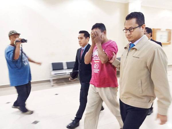 Mohd Rafiq (tengah) didakwa di Mahkamah Sesyen Kuantan hari ini atas pertuduhan menawarkan dan memberi suapan kepada pegawai polis.