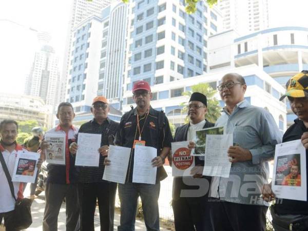 Mohd Noor Ali (tiga dari kiri) bersama NGO lain membuat laporan di Ibu Pejabat Polis Daerah Dang Wangi, di sini hari ini.