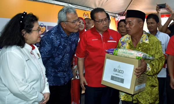 Mohd Redzuan (empat, kanan) bersama tiga koperasi sekolah negeri Melaka yang menerima 'papan tanda jimat biz' Program Pembekalan Barangan Asas 100 (BA100) Program Mesra Koperasi Bazar Jualan Harga Patut BA100. -Foto Bernama