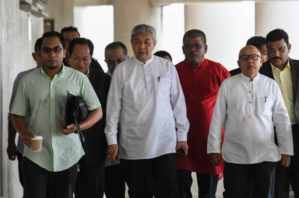 Dr Ahmad Zahid Hamidi (tengah) hadir di Mahkamah Tinggi hari ini. -Foto Bernama