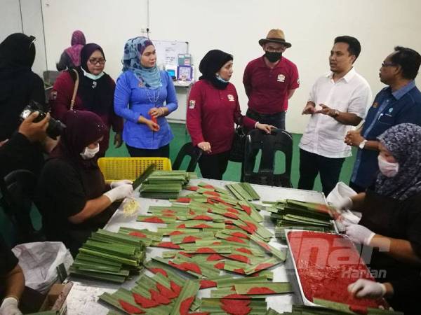 Haslina (tengah) mendengar penerangan Nik Fadzli (dua dari kanan) mengenai pemprosesan sata dan otak-otak yang diusahakan di Taman Angsana Sungai Petani sempena Jelajah Agropreneur Muda 2020 semalam.