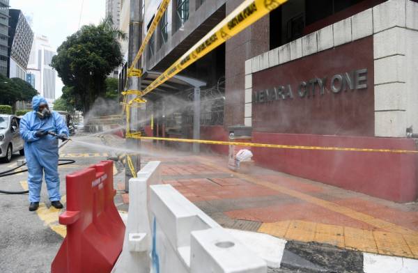 Proses penyahkuman atau disinfeksi sekitar Menara City One. -Foto Bernama