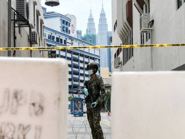 Anggota tentera dari Unit Batalion Pertama Rejimen Renjer Diraja mengawal laluan keluar masuk jalan yang menghubungkan Selangor Mansion, Malayan Mansion dan Jalan Masjid India ketika tinjauan berkenaan Perintah Kawalan Pergerakan (PKP) yang masuk hari ke-28 di sekitar Jalan Tuanku Abdul Rahman hari ini. - Foto: Bernama