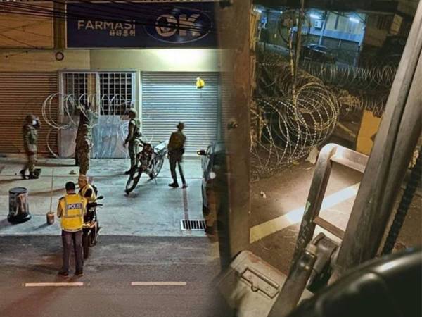 Pasukan ATM memasang kawat duri di pintu masuk sebuah bangunan di Jalan Selayang Baru.