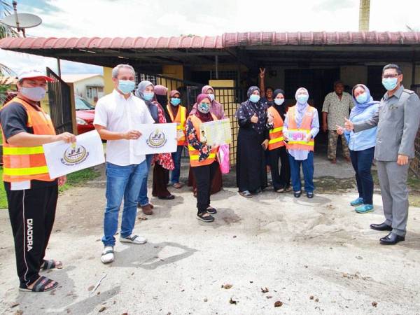 Ahmad Faizal (kanan) dan isteri, Datin Seri Dr Nomee Ashikin Mohammed Radzi (dua dari kanan) turut bersama Rumah Ngaji Kediaman MB Perak menyampaikan sumbangan kepada mereka yang memerlukan di sekitar Ipoh baru-baru ini.