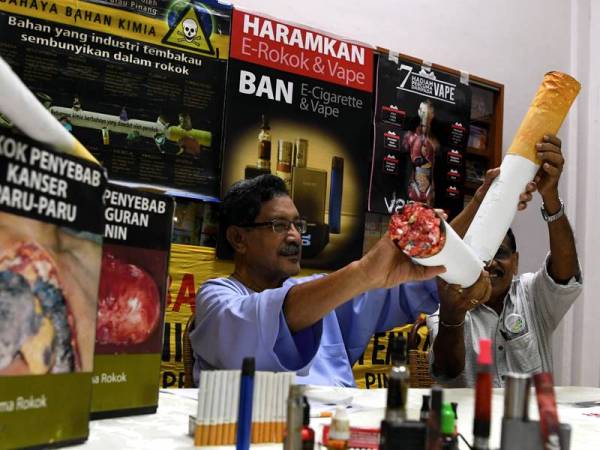 Mohideen (kiri) melakukan simbolik memusnah batang rokok semasa mengadakan sidang akhbar sempena sambutan Hari Tanpa Tembakau Sedunia pada 31 Mei ini dengan tema Belia. - Foto Bernama