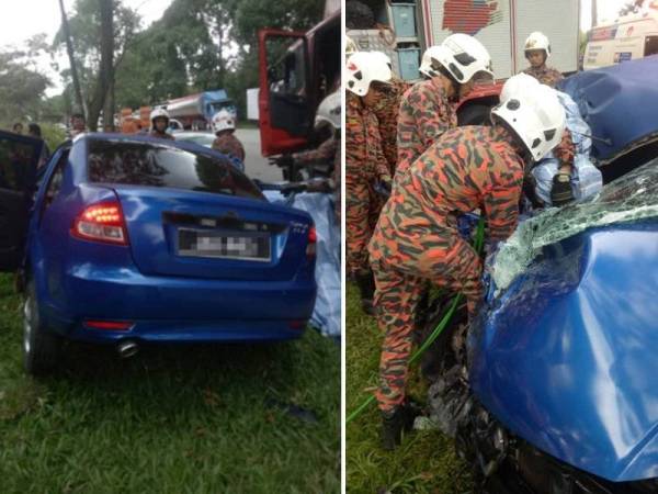 Anggota bomba berusaha untuk mengeluarkan mangsa yang tersepit di lokasi kemalangan melibatkan kereta dan lori tangki minyak di Jalan Ayer Hitam- Johor Bahru, hari ini.