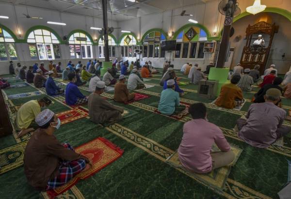 Para jemaah khusyuk mendengar khutbah yang disampaikan Imam Muda Masjid Alor Pasir Kamaruddin Ibrahim dengan menjaga jarak antara satu sama lain semasa solat Jumaat di Masjid Alor Pasir, Wakaf Bharu hari ini. -Foto Bernama