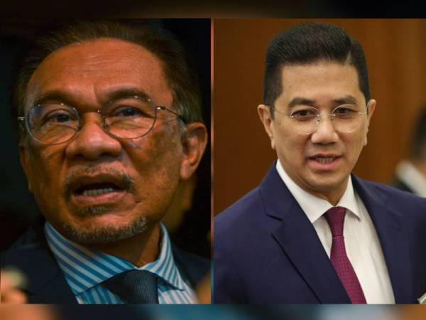 Anwar Ibrahim (kiri) dan Mohammed Azmin 