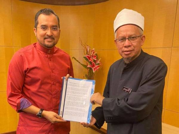 Zulkifli (kanan) menerima Memorandum Mendesak Penubuhan RCI TH daripada Asyraf Wajdi (kiri) di pejabatnya hari ini.