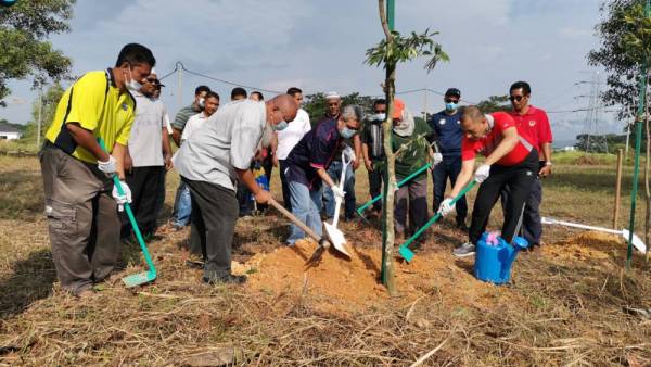 Rumaizi (tengah) menanam pokok sebagai simbolik dalam majlis Penyampaian Sijil kepada RPT Pengkalan Permai hari ini. 