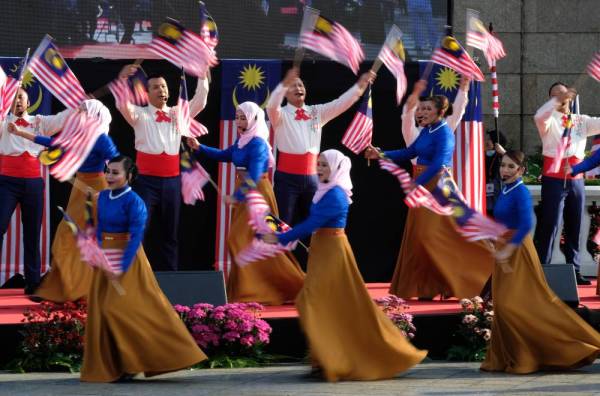 Artis Pentarama Jabatan Penerangan menyanyi sambil mengibarkan Jalur Gemilang pada majlis pelancaran Sambutan Bulan Kebangsaan dan Kibar Jalur Gemilang 2020 di Dataran Perdana, Bangunan Perdana Putra hari ini. Majlis itu disempurnakan Perdana Menteri Tan Sri Muhyiddin Yassin. - Foto Bernama