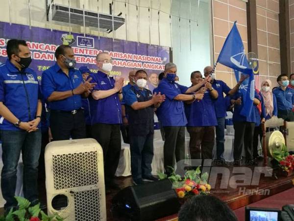 Ahmad Zahid menyerahkan bendera kepada Pemangku Ketua UMNO Bahagian Tanjung Malim, Mohd Zaidi Aziz sebagai simbolik penyerahan PDM angkat pada majlis tersebut.