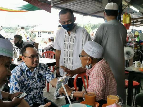 Maszlee (tengah) bersama Amir Khusyairi pada program Walkabout di Felda Trolak Utara hari ini.