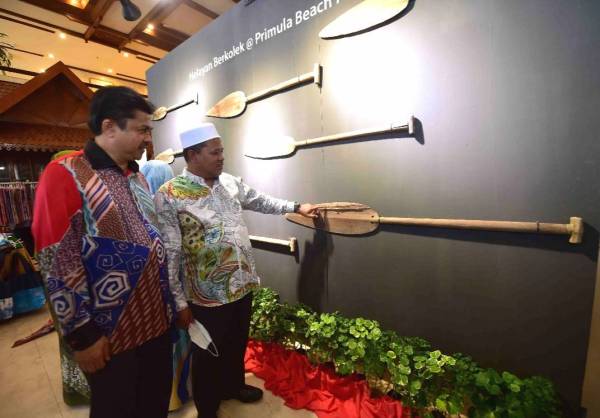 Ariffin (kanan) dan Ahmad Fathil melihat pameran dengan tema nelayan berkolek sempena Festival Kebudayaan di Primula Beach Hotel, Kuala Terengganu.