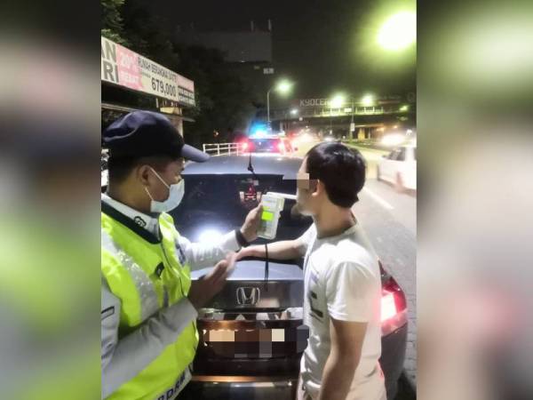 Salah seorang pemandu sedang menjalani ujian kandungan alkohol dalam Ops Alkohol dan Pencegahan Jenayah di Petaling Jaya malam tadi.