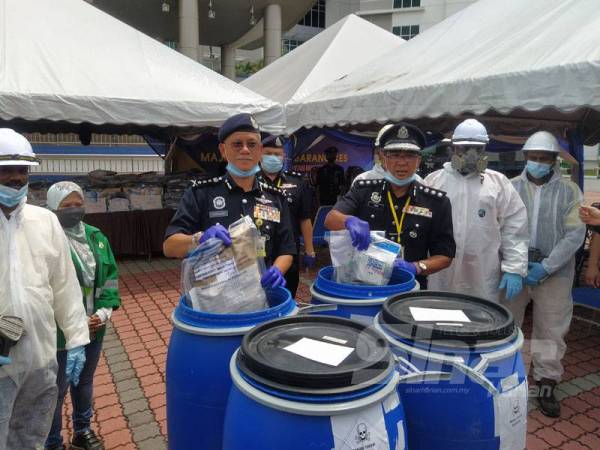 Hasanuddin membuang barang kes dadah ke dalam tong pada Majlis Pelupusan Barang Kes Jabatan Siasatan Jenayah Narkotik di Ibu Pejabat Kontijen (IPK) Kedah hari ini.