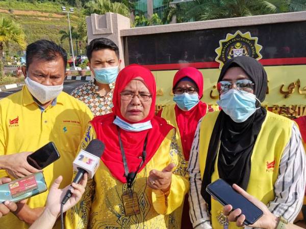 Hamidah (tengah) ketika ditemui media selepas membuat laporan SPRM di Meru Raya hari ini.