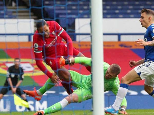 Pelanggaran van Dijk dan penjaga gol Everton, Jordan Pickford pada aksi derby Merseyside minggu lalu. - Foto: AFP via Gettyimages