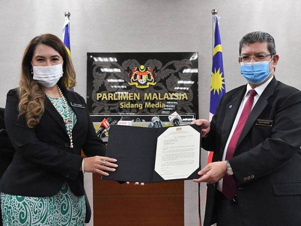 Menteri Komunikasi dan Multimedia Datuk Saifuddin Abdullah (kanan) menyerahkan surat pelantikan Pengerusi Pertubuhan Berita Nasional Malaysia (Bernama) yang baharu kepada Senator Ras Adiba Radzi di Bangunan Parlimen hari ini. - Foto Bernama