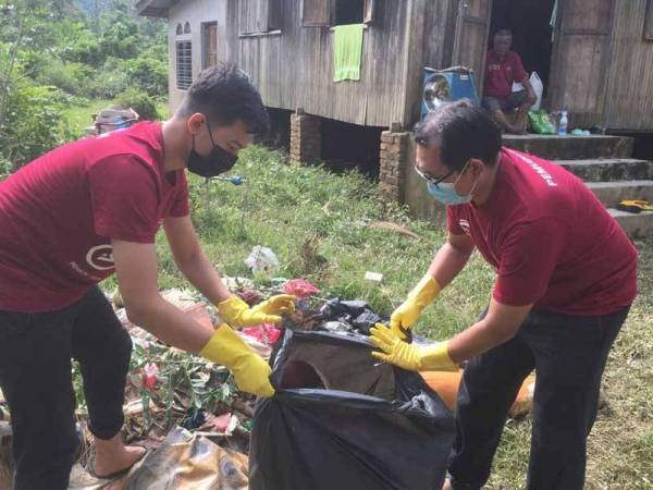 Sukarelawan membantu membersihkan kediaman mangsa banjir di Kampung Kuala Jengal, Dungun.