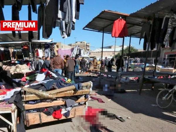 Inilah lokasi kejadian dua letupan bunuh diri di sebuah pasar menjual pakaian terpakai di Dataran Tayaran, Baghdad pada Khamis lalu. - Foto AFP