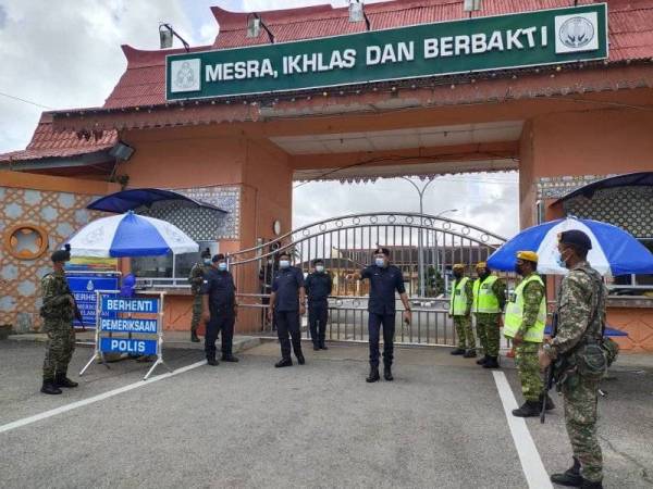 Mohd Zain (tengah) turun padang membuat tinjauan kawalan ketat di pintu utama keluar masuk di Penjara Marang, Marang pada Khamis.