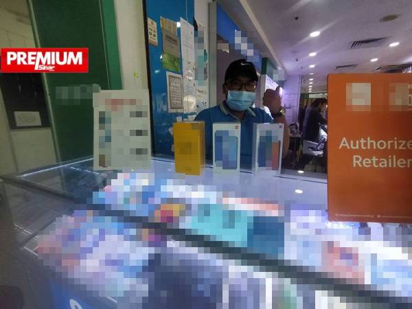 Muhammad Azri Izham menunjukkan sebahagian telefon pintar yang menjadi pilihan ibu bapa di sebuah kedai di UTC Kedah di sini.