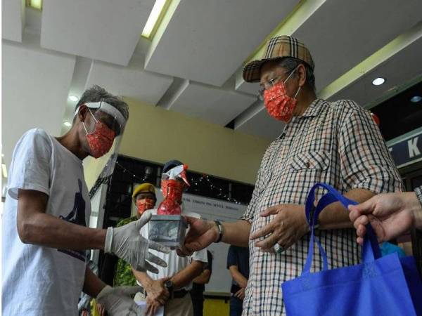 Menteri Wilayah Persekutuan, Tan Sri Annuar Musa memberi sumbangan kepada gelandangan pada program Urban Farming di Wilayah Persekutuan di Pusat Gelandangan Sentul pada Sabtu. - fotoBERNAMA