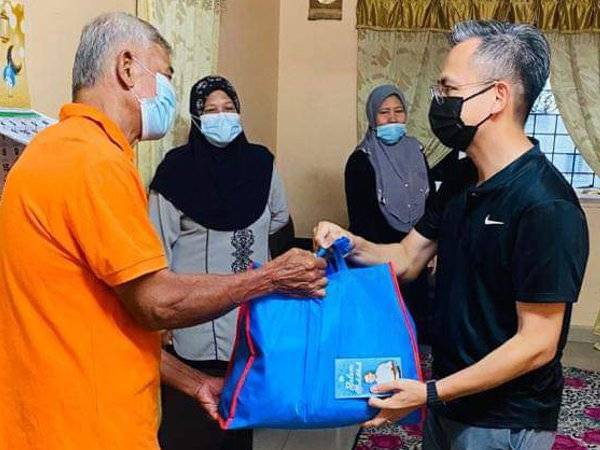 Fahmi menyampaikan sumbangan zakat kepada salah seorang mangsa kes kebakaran kenderaan di PPR Pantai Ria, Jalan Pantai Dalam di sini pada Rabu.